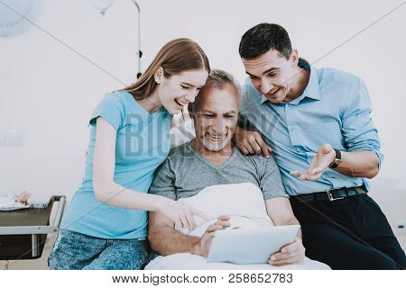 Old And Young People In Clinic With Laptop. Help Old Man With Laptop And Health. Clinic Room With Ol