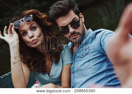 No Cares And No Rules. Self Portrait Of Beautiful Young Couple Looking At Camera While Sitting In Th