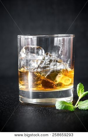 Glass Of Rum On The Dark Background