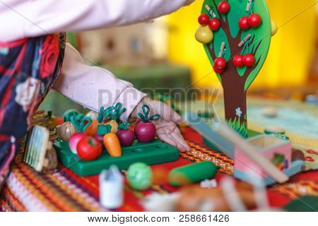 Concentrated Boy Puts Colorful Coins During Aba