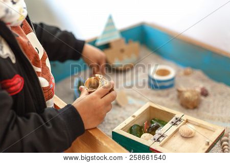Sand Therapy. The Child Is Built In A Sandbox World