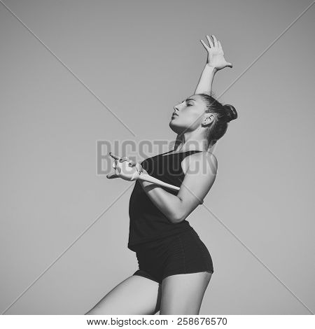 Woman Gymnast In Black Sportswear With Green Mace. Gymnastic School And Energy. Flexibility In Acrob
