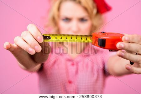 Woman In Pin-up Style Holding Ruller. Pin-up Girl Holds Construction Ruler. Pin Up Style. Woman In R