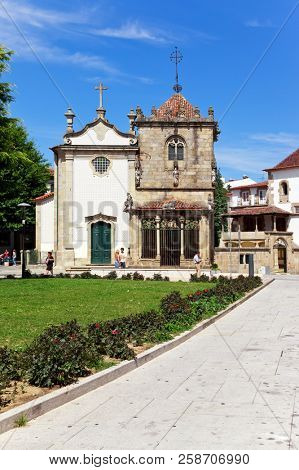 Braga, Portugal - July 27, 2015: Sao Joao do Souto Church (left) and Coimbras Chapel (right). Medieval religious architecture.