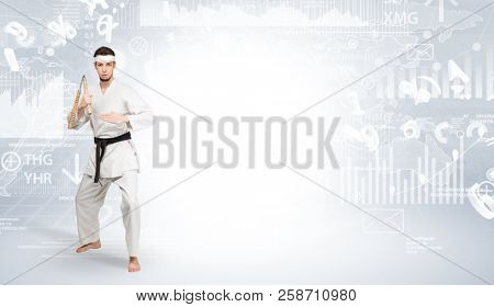 Young karate trainer doing karate tricks on the top of a metropolitan city