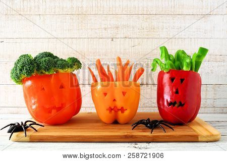 Healthy Halloween Food. Vegetables For Dipping In Jack O Lantern Bell Peppers. Scene Against White W