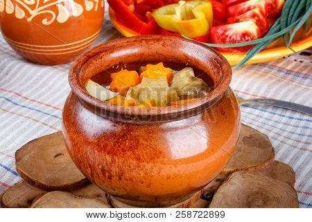 Traditional Rustic Home  Gulyas, With Raw Vegetables And Spices In Clay Pots On  Old Vintage Wooden 