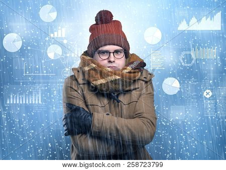 Young businessman shivering with graphs, reports and chart concept