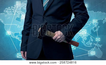 Businessman holding tool with global map graphic on the background
