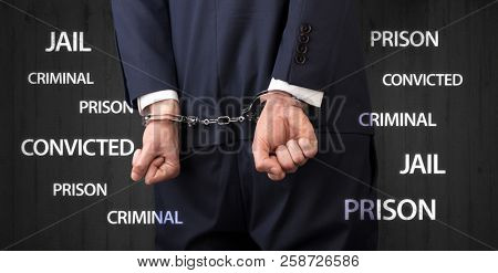 Jail convicted prison criminal labels with close handcuffed man