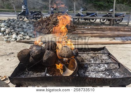 Coconuts Burning For A Fish Bbq Near Blue Stone Beach, Ende, Indonesia.