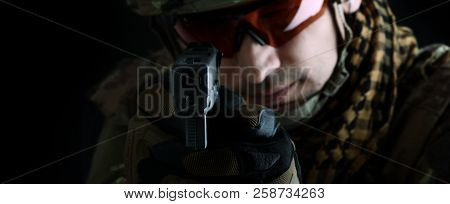 Aiming At The Camera Focus On The Muzzle Of Gun