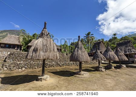 Traditional Ngadhu Poles In The Luba Traditional Village With Mount Inerie In The Distance On The Is