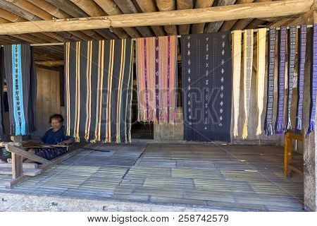 Luba, Indonesia - May 19: An Unidentified Woman Weaves On Her Front Porch In The Luba Traditional Vi