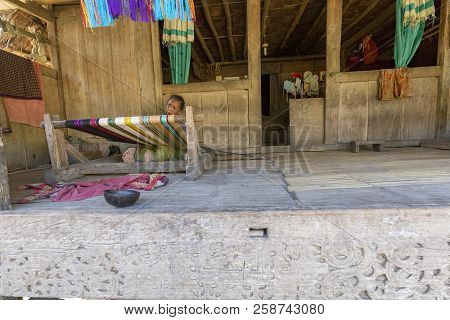 Luba, Indonesia - May 19: An Unidentified Woman Weaves On Her Front Porch On May 19, 2017 In Luba, I