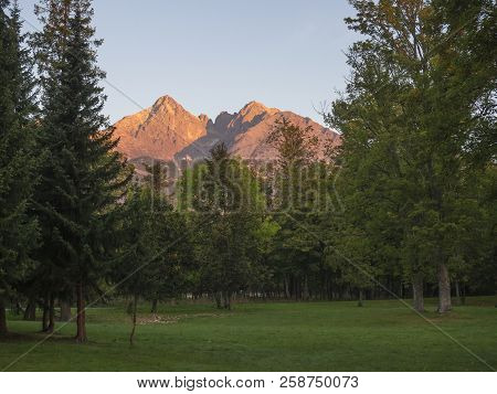 Tatra Mountains Range Colored Pink And Orange Sunrise Light , View From Tatranska Lomnice With Green