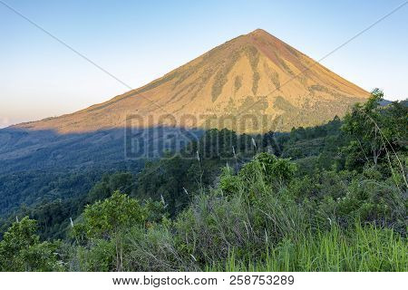 Dawn Sunlight Illuminates Mount Inerie On Flores In Indonesia.