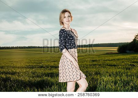 Young Girl In A Green Field. Stylish Girl. Green Grass And Blue Sky. Emotional Woman. Plener. Travel