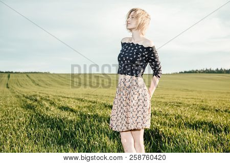 Young Girl In A Green Field. Stylish Girl. Green Grass And Blue Sky. Emotional Woman. Plener. Travel