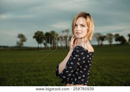 Young Girl In A Green Field. Stylish Girl. Green Grass And Blue Sky. Emotional Woman. Plener. Travel