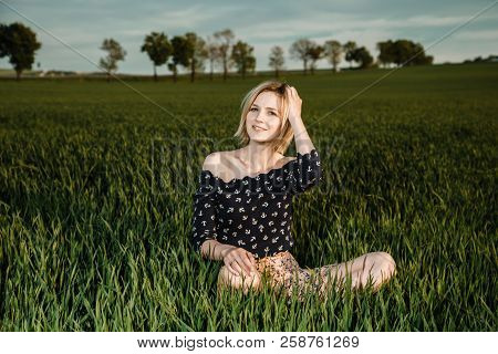 Young Girl In A Green Field. Stylish Girl. Green Grass And Blue Sky. Emotional Woman. Plener. Travel