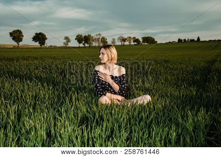 Young Girl In A Green Field. Stylish Girl. Green Grass And Blue Sky. Emotional Woman. Plener. Travel
