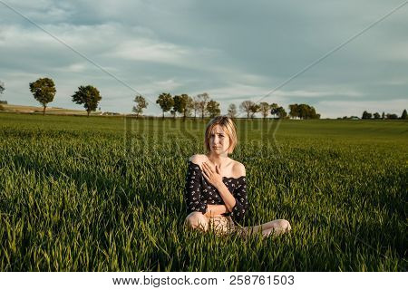 Young Girl In A Green Field. Stylish Girl. Green Grass And Blue Sky. Emotional Woman. Plener. Travel