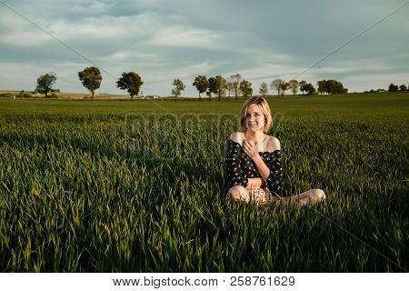 Young Girl In A Green Field. Stylish Girl. Green Grass And Blue Sky. Emotional Woman. Plener. Travel