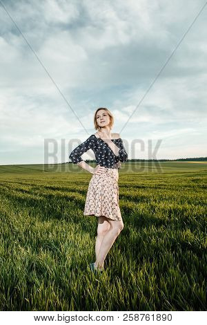 Young Girl In A Green Field. Stylish Girl. Green Grass And Blue Sky. Emotional Woman. Plener. Travel