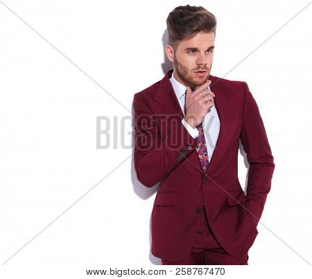 portrait of a modern business man thinking and looking to side on white background