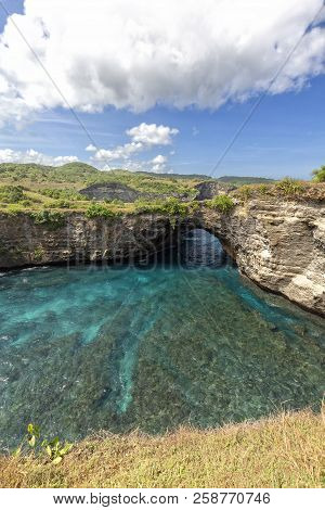 Portrait View Of Beautiful Tropical Ocean And Natural Rock Arch At Broken Beach In Nusa Penida.