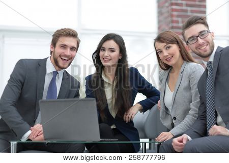 Business people are using a laptop during the conference in offi