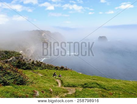 Admiring The Beautiful Sights Of The Skerwink Trail Outside Of Trinity, Along The Rugged Coasts Of N