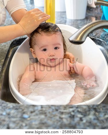 Baby Boy Taking A Bath In A Little Bath Tub