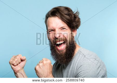 Victory Success And Achievement. Excited Thrilled Agitated Guy Making A Winner Gesture. Hipster Man 