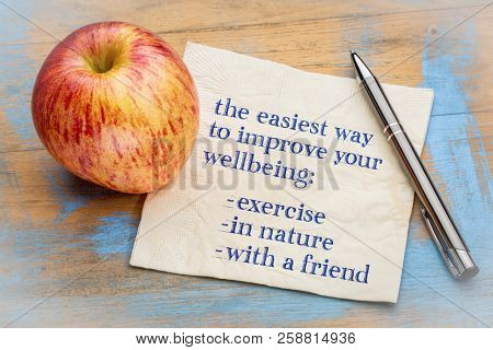 advice on improving your wellbeing - exervice, in nature, with a fiend - handwriting on napking with a fresh apple