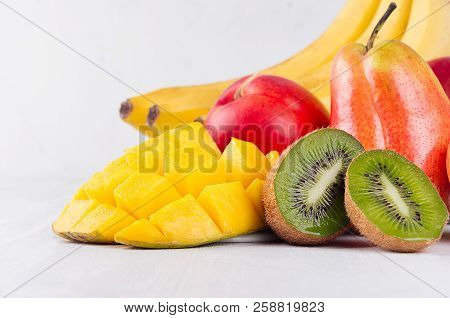 Bright Ripe Extotical Fruits Of Red, Yellow, Green, Orange Color With Juicy Sliced Slices Macro On W