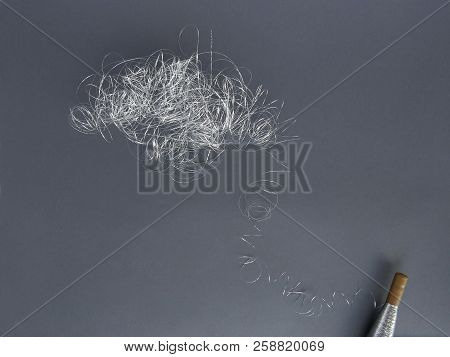 Silver Thread Pile Like Cloud And Spool Of Silver Thread. Pile Of Silver Thread On Grey Background.