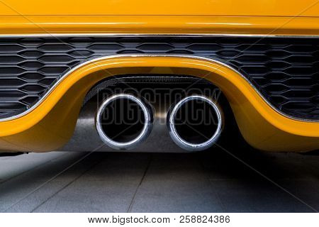 Orange Sports Car Exhaust Pipe. Chrome Exhaust Pipe Bumper