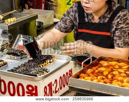 Seoul, South Korea - June 21, 2017: Woman Vendor Serving Customers At Gwangjang Market In Seoul.