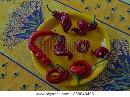 Eigth Red Hot Chili Peppers On A Yellow Plate