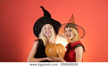Happy Brightful Positive Moments Of Two Stylish Girlson Orange Background. Surprise. Halloween Girls