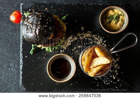 Delicious Black Beef Burger With Soia Sos And French Fries