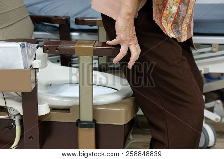 Old Woman Use Portable Mobile Plastic Toilet Near  Patient Bed