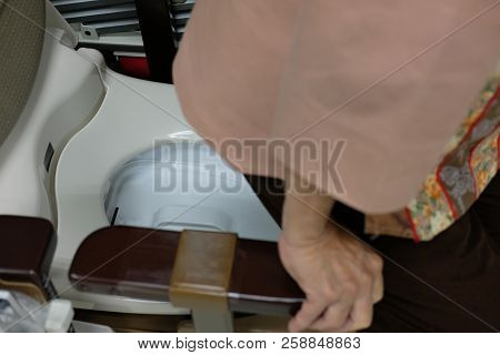 Old Woman Use Portable Mobile Plastic Toilet Near  Patient Bed