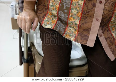 Old Woman Use Portable Mobile Plastic Toilet Near  Patient Bed