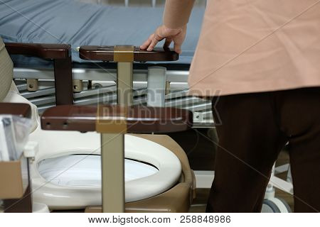 Old Woman Use Portable Mobile Plastic Toilet Near  Patient Bed