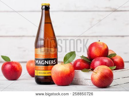 London, Uk - September 13, 2018: Bottle Of Magners Original Cider With Fresh Apples On Wood Backgrou