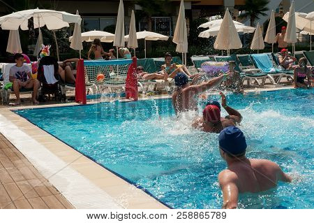 Turkler, Turkey - July 30, 2018: A Group Of People Playing In The Pool In A Water Polo Ball. Athlete