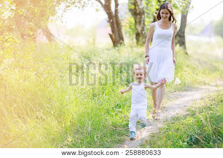 Mother And Son Having Fun Running And Playing Together At The Patk